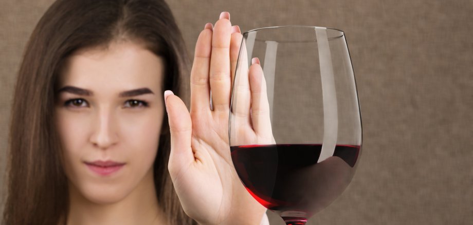 reject liquor, stop alcohol, teenager girl shows a sign of refusal of wine