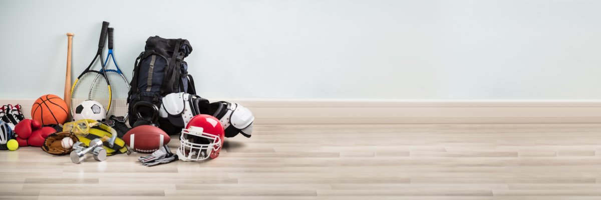 Different Type Of Sports Equipment On Wooden Desk