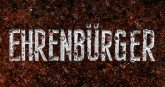 Brauner Untergrund mit weißen Buchstaben, die das Wort Ehrenbürger ergeben.