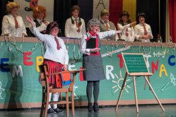 Zwei Frauen bei ihrem Auftritt bei der Weiberfastnacht. Im Hintergrund die Frauen des Elferrats.