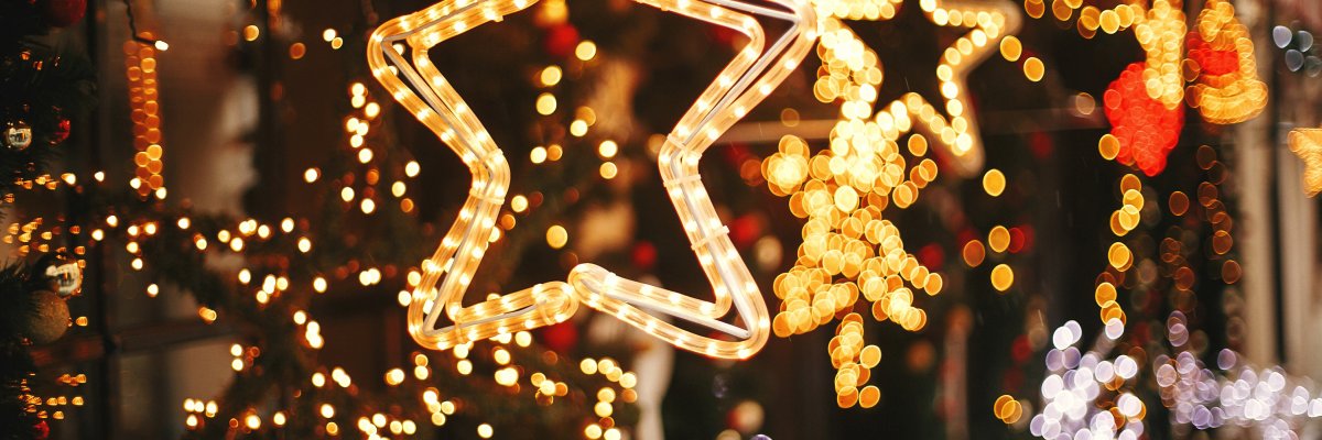 Stylish christmas golden star illumination and fir branches with